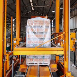 An industrial machine in a glass factory showcasing automated packaging in Dar es Salaam.